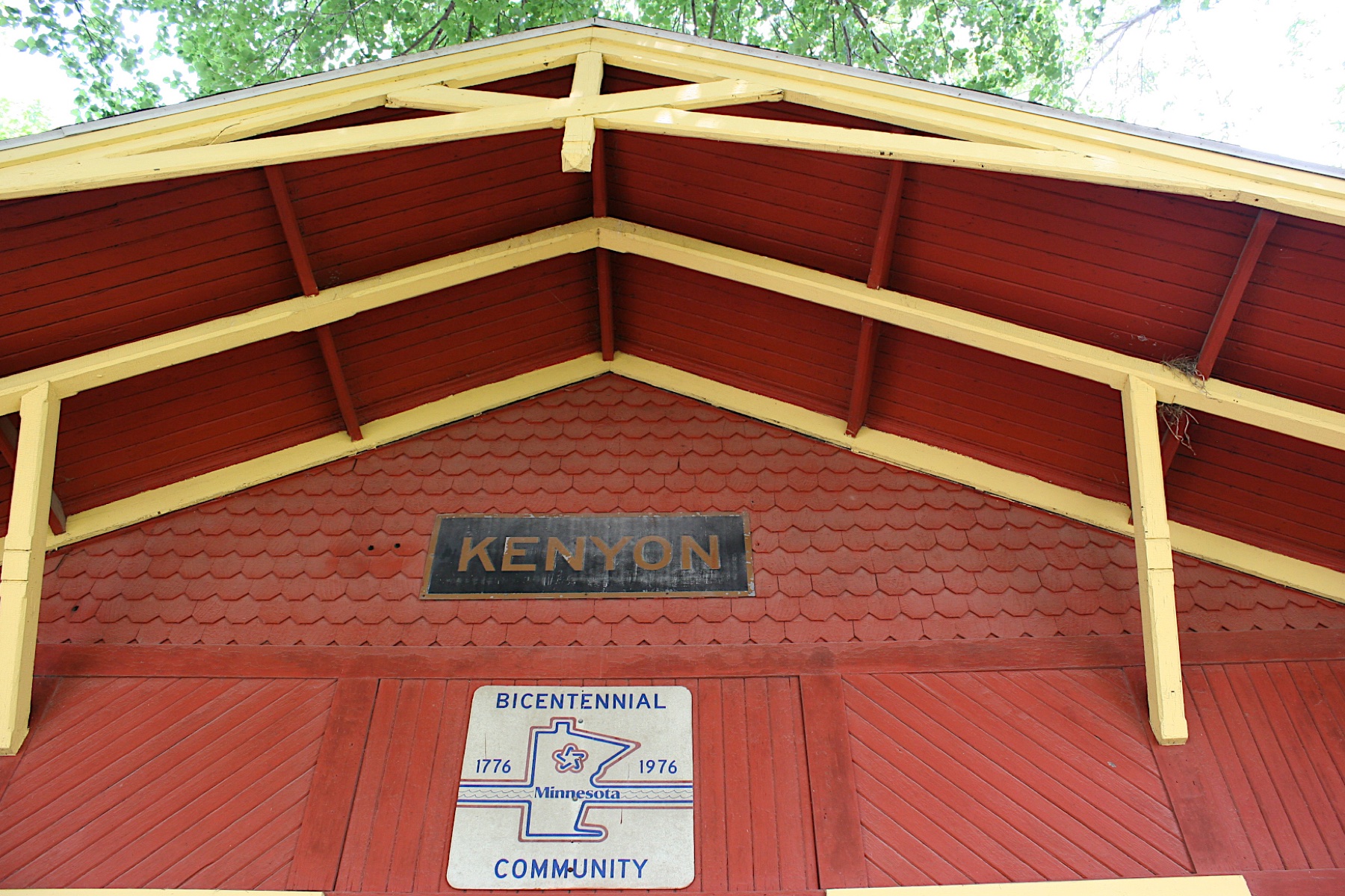 Gable of the depot with the KENYON sign and the 1976 Bicentennial Community plaque
